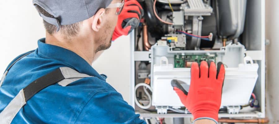 Technician Trying To Fix the Problem with the Residential Heating Equipment