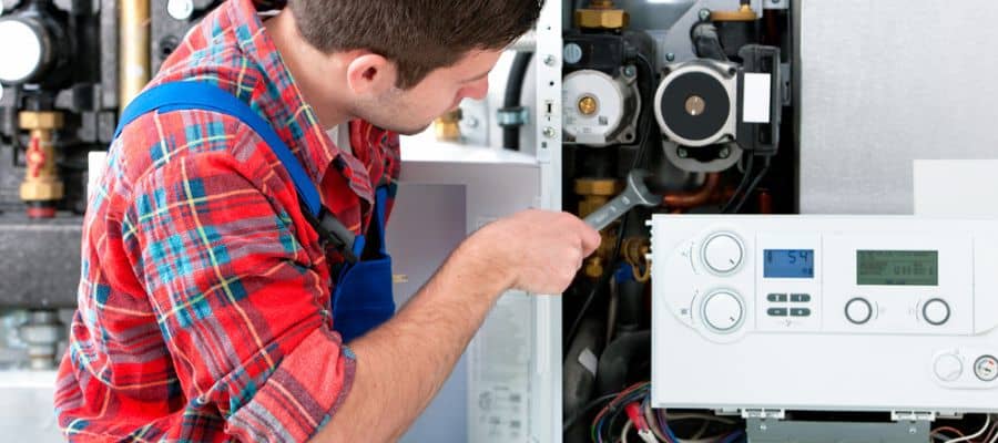 Technician servicing the gas boiler for hot water and heating